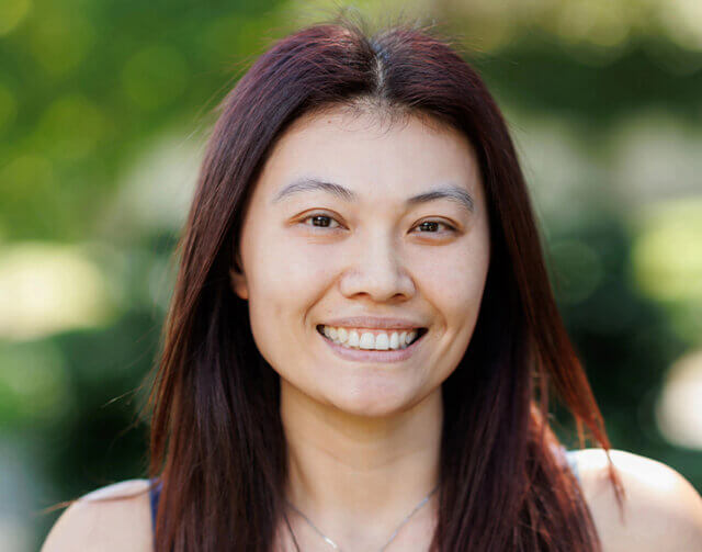 Woman smiling in red hair.