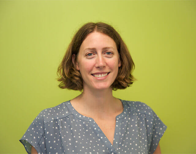 Woman in light brown hair in blue blouse.