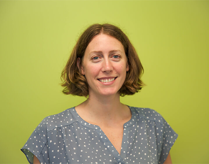 Woman in light brown hair in blue blouse.