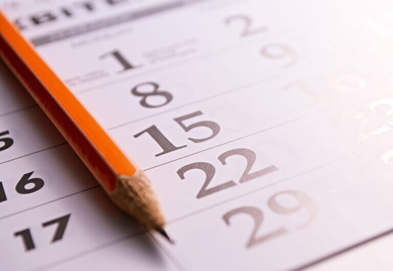 closeup of a calendar page with a pencil on top