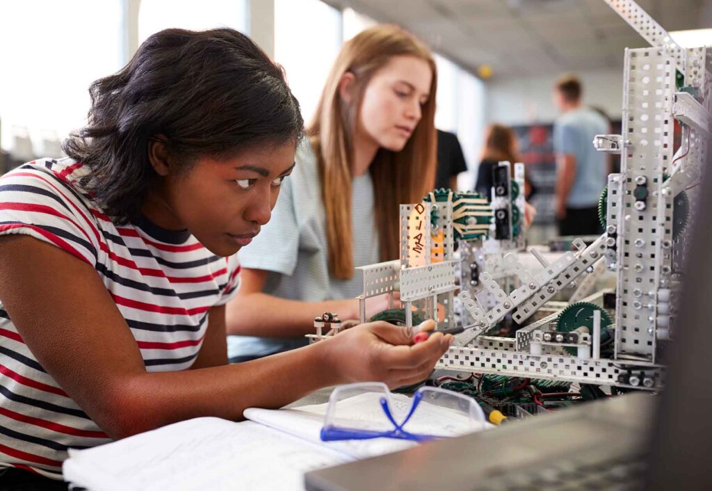 two women work on building a model