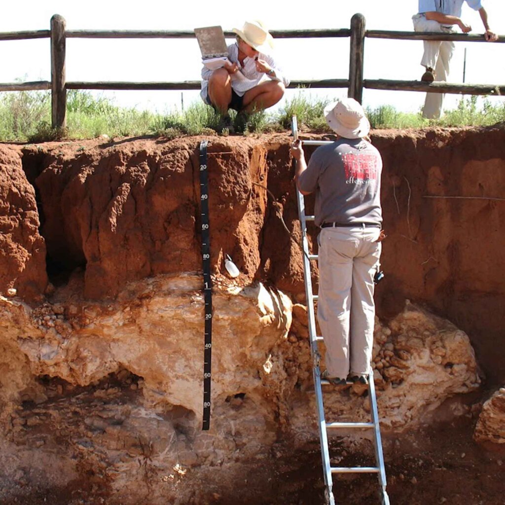 two researchers study a wall of soil in las cruces, nm