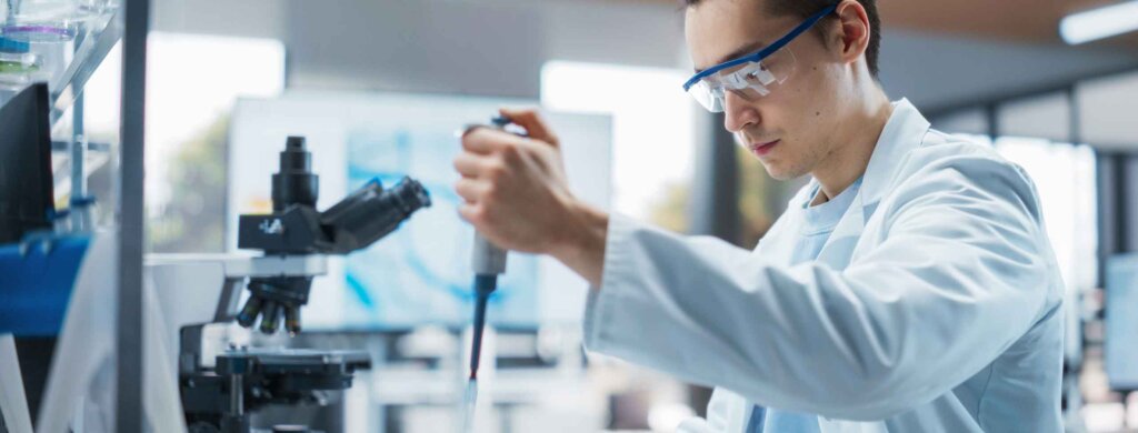 a student uses a pippete to add liquid to a vial