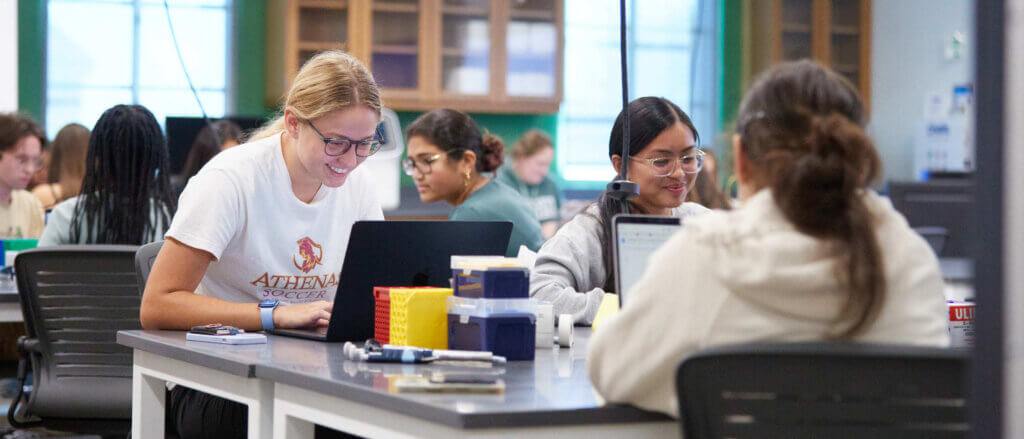 Students work on laptops in a biology lab