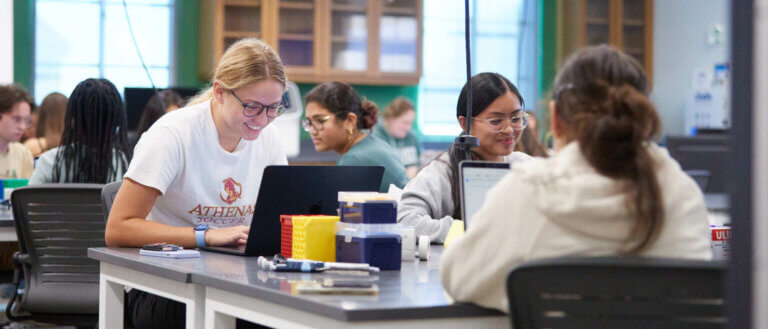Students work on laptops in a biology lab