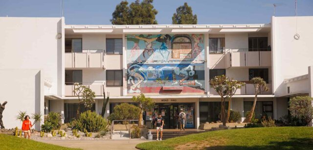 students walk in front of Mead's mural-decorated entrance