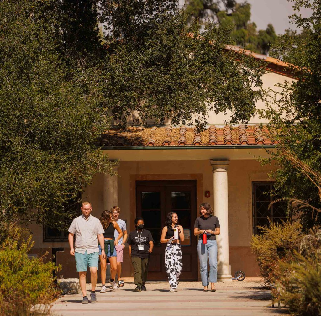 a group of five students leave the entrance of the RRC surrouded by oak trees
