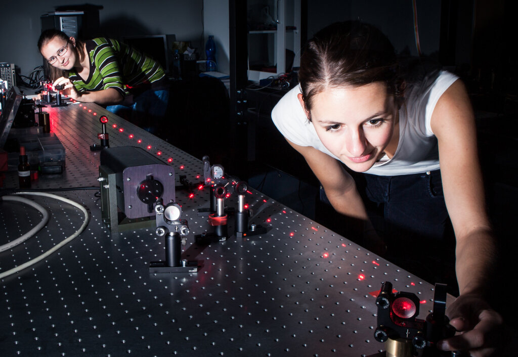 Two students perform an experiment involving a laser
