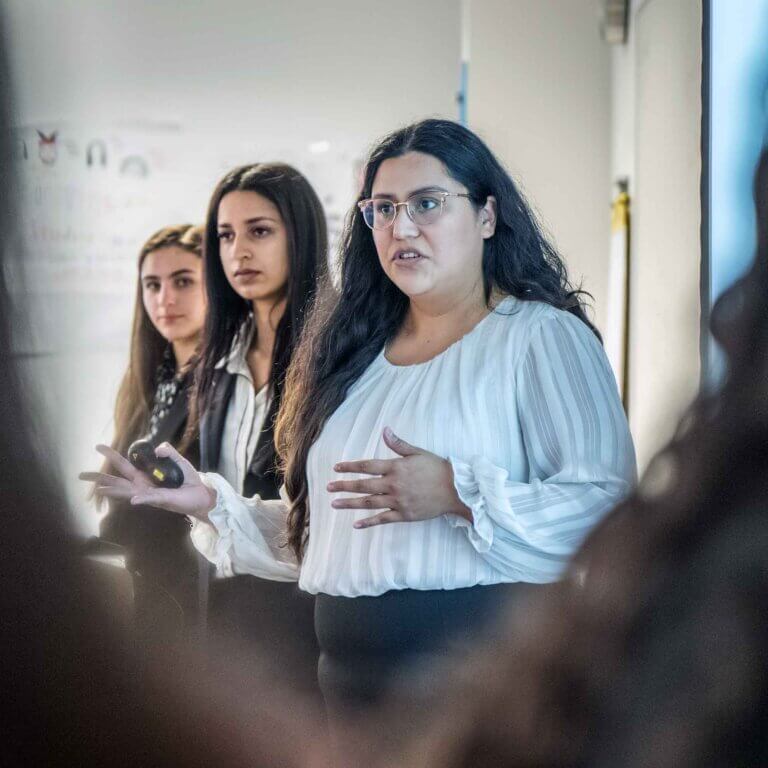 three students give a presentation