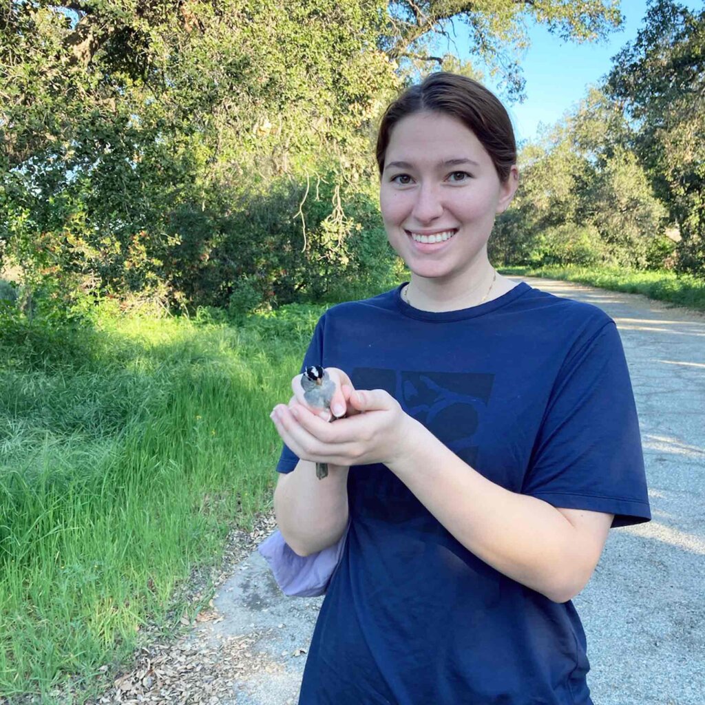 a student holds a bird at the bernard field station