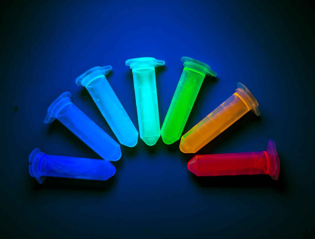 seven multicolored perovskites sit on a blue background