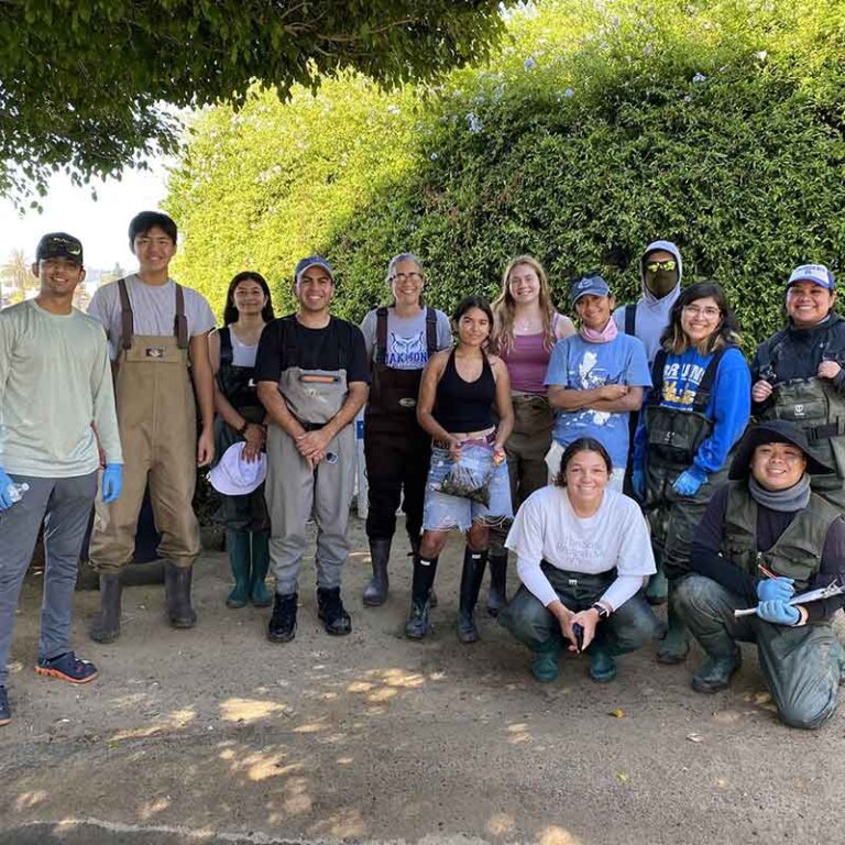 professor gilman poses with her research group students