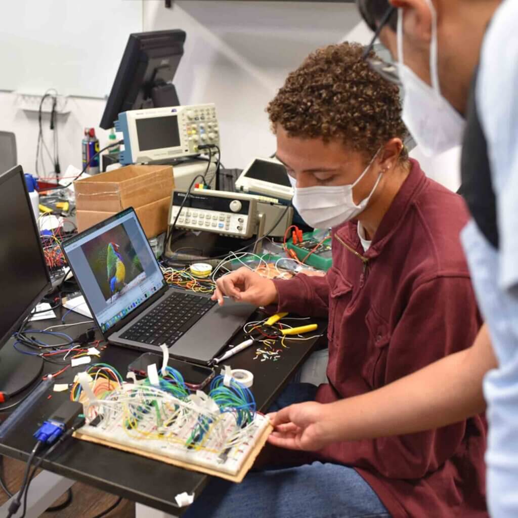 Biophysics major MJ Lindsey CMC '23 debugs a custom-built video graphics card.