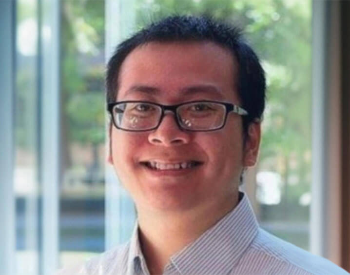portrait of Trung Phan wearing a collared shirt and black glasses