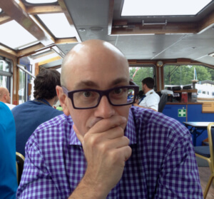 Professor Michael Spezio poses for a picture wearing a pair of glasses.