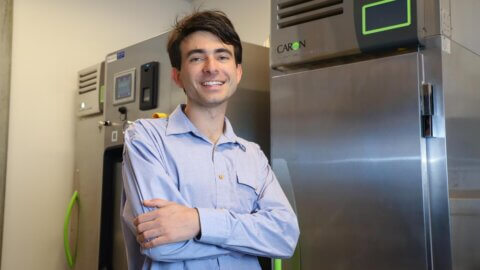 Lucas Oppenheimer stands in a science lab